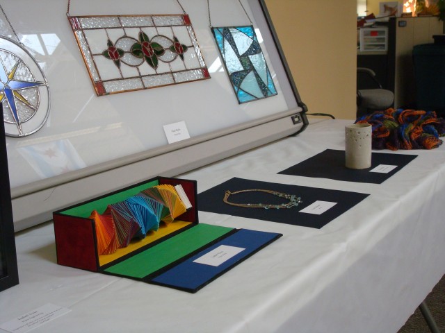Stained glass by Paula Baylis; Colorful paper sculpture by Isabel Uria
